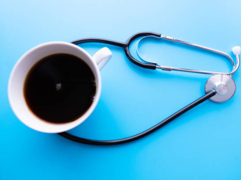 coffee cup and stethoscope, relaxing concept for doctor. On a blue background. Medical background concept